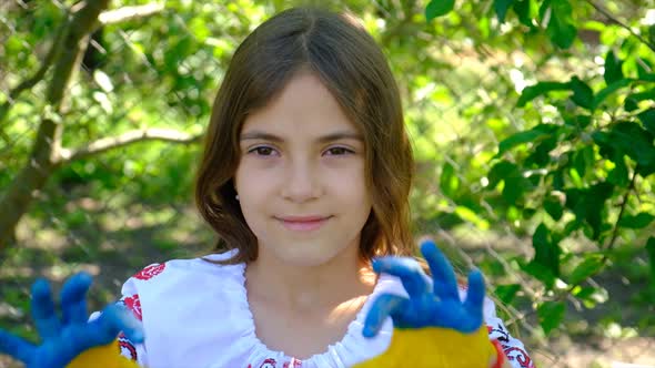 The Ukrainian Flag is Drawn on the Child Hands