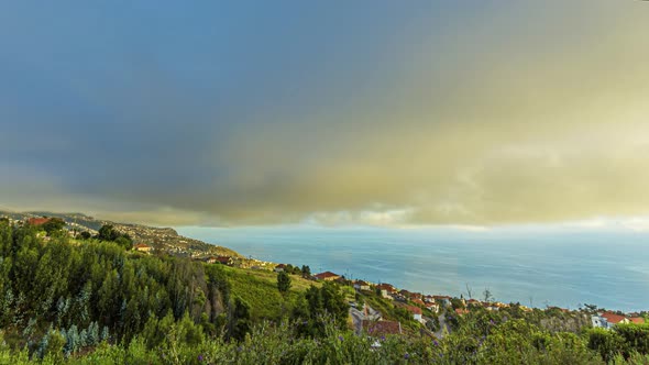 Time lapse movie of sunset over the city of Calheta on Madeira island on a cloudy day