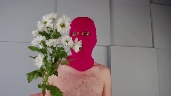 Anonymous Shirtless Man in Balaclava with Flowers