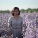 Asian woman happily walking in a purple flower garden, slow motion. - VideoHive Item for Sale