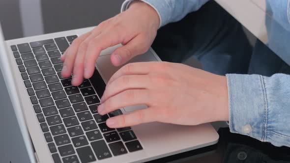 Male hands of business man worker using typing on laptop notebook keyboard