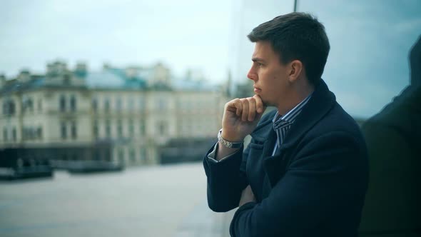 A Sad and Depressed Businessman Standing Alone Outdoors