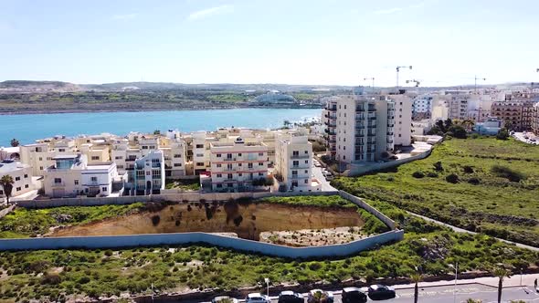 Massive building foundation ready for build. Malta island development. Aerial ascend view