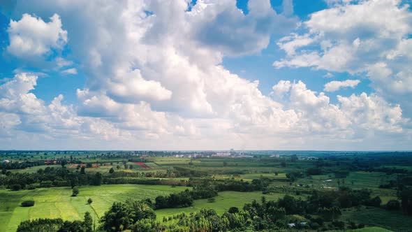 time lapse of beautiful Green farming community and a factory on a beautiful cloudy day.