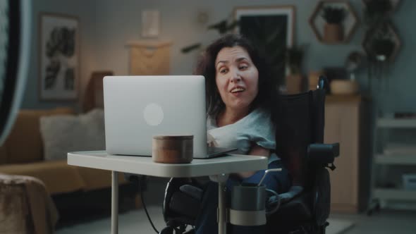Woman with a Disability Editing Video on Laptop