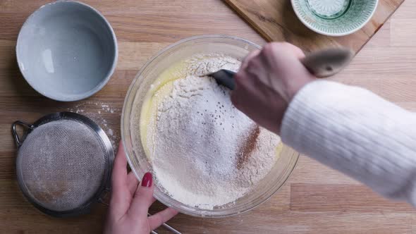 Female Hands Mixing Ingredients to Carrot Cake Dough. - Top Down Shot