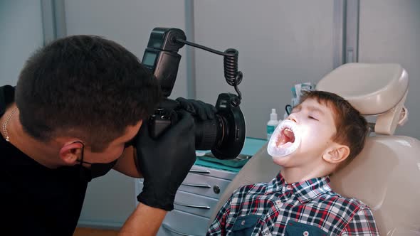 A Little Boy Having a Treatment in the Dentistry - Taking Photos of the Boy's Teeth