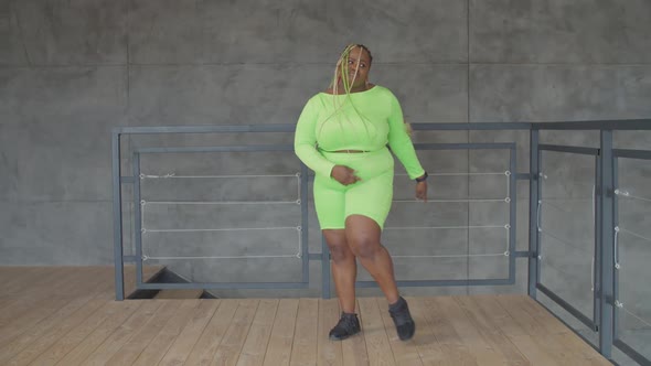 Happy Overweight African Female Dancing at Home