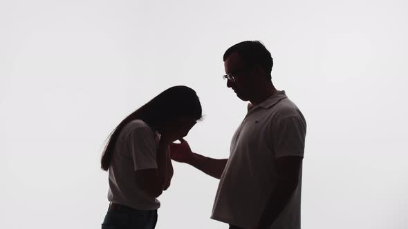 Silhouette of Crying Woman After Quarrel Comforted By Man Stroking Her Head White Background in