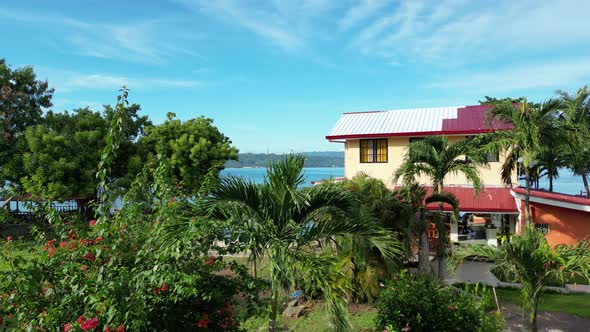 Aerial Shot of a House with a Private Pool in the Coastal Area