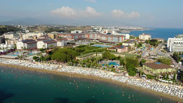 Aerial View of People Crowd Relaxing on Beach and Sea with Waves. Top View From Flying Drone.