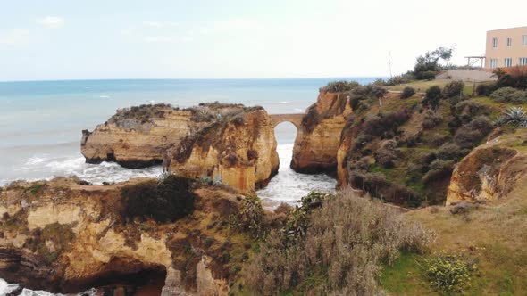 Arched Primitive stone Bridge At Student Beach In Lagos, Algarve, Portugal