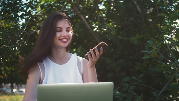 Girl Using Smart Phone Voice Recognition, Dictates Thoughts, Voice Dialing Message at Night Evening