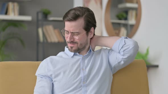 Portrait of Young Man Having Neck Pain