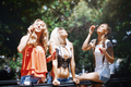 Three girlfriends blowing bubbles outdoors - PhotoDune Item for Sale