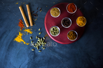 Variety of spices and herbs on kitchen table / Photodune, Misc