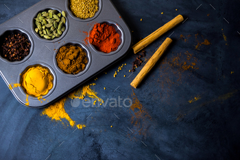 Variety of spices and herbs on kitchen table / Photodune, Misc