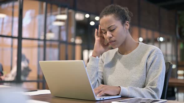 African Woman with Headache Working on Laptop