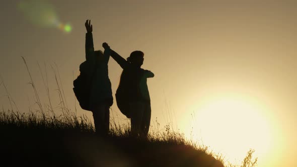 Hiker Girl Raising Her Hand Up, Celebrating Victory And Enjoying Scenery