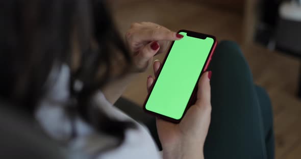 Woman using a smart phone with green screen