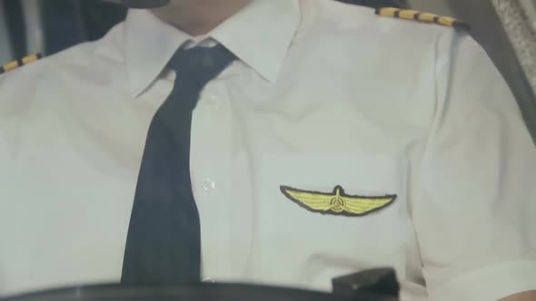 Pilot's Insignia on Uniform, Captain Controlling Airliner, Thinking About Home