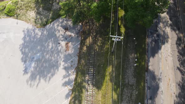 Birds eye track of old train tracks leading to a marina.