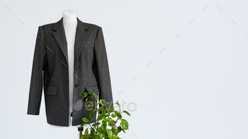 , ecology, sustainability, responsible fashion, 100 cotton. Formal Bio fabric suit with green plants on light background