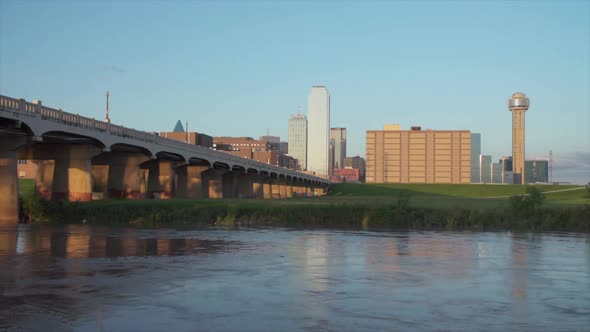 Dallas Skyline with the Trinity River in the foreground during sunset. - FAST Moving Water - 1080p
