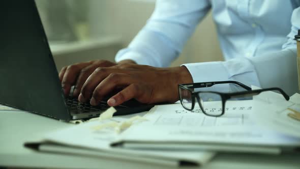 Close Up of Handsome Mans Hands Working on Laptop