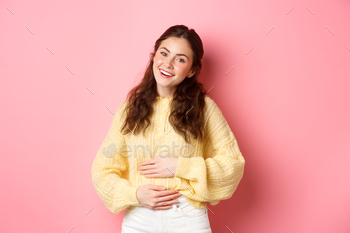 eved, happy face, feeling good after eating yoghurt or medicine from painful cramps, standing against pink background.