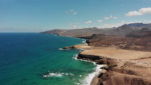 Aerial drone shot of the coastline of Playa La Pared in Fuerteventura on a sunny, cloudless day. Bea