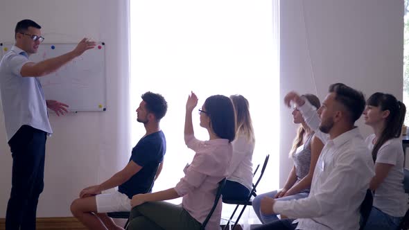 Successful People at Training, Speaker Listens To Young Guy Colleague About Development of Business