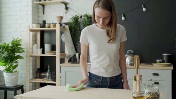 Housekeeping Concept  Happy Woman Cleaning Table at Home Kitchen