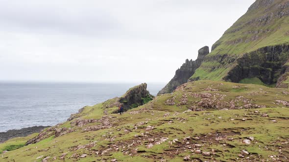 Aerial Back View of Huge Cliffs in Faroe Islands Green Rocky Mountainpowerful Ocean Wavesin a Cloudy