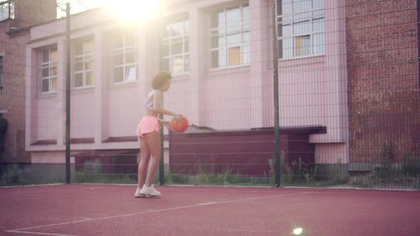 Young Woman Playing Basketball