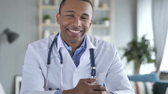 Smiling Positive AfricanAmerican Doctor At Work Looking at Camera