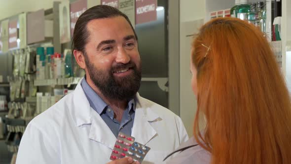 Friendly Male Pharmacist Selling Pills To Female Customer