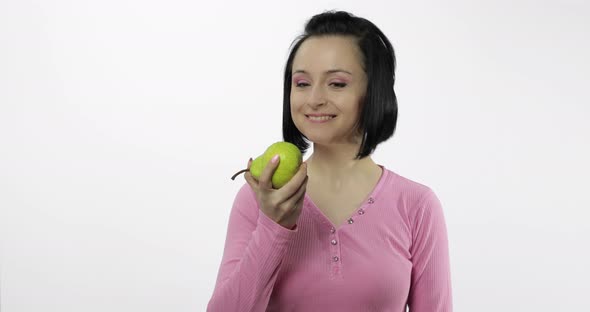Woman Eating Fresh Pear and Says Yum. Girl Takes First Bite and Say Wanna Bite