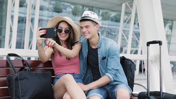 Couple Traveling, Making Photo On Phone Near Airport