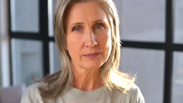 Closeup Portrait of Cheerful Senior Female Entrepreneur in Bright Modern Office