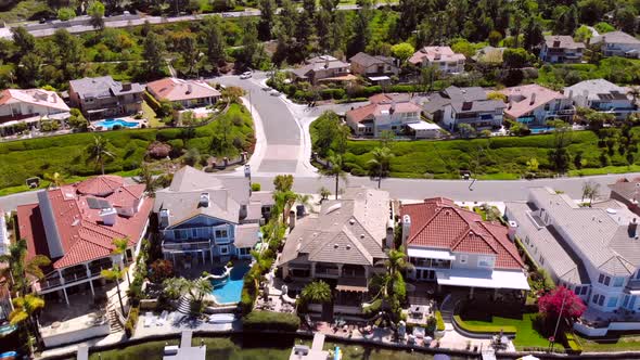 Aerial pull back of luxury homes on community lake mission viejo