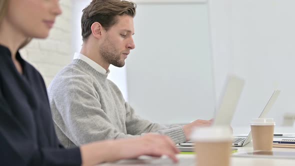 Close Up of Creative Startup Team Working on Laptops in Office