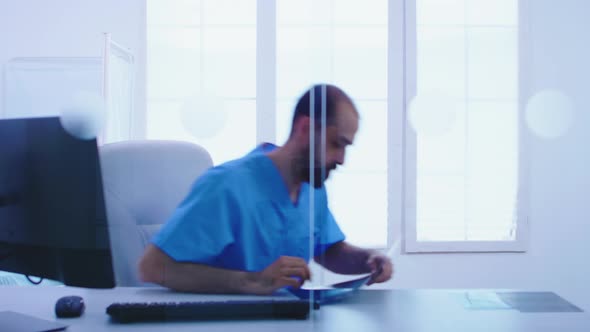 Doctor and Assistant Looking at Patient Xray