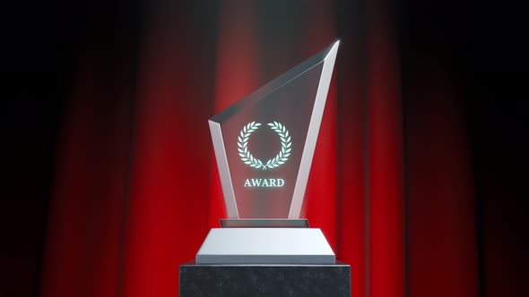 Crystal glass award on a stage with a red curtain in the background. 4KHD