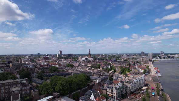 Aerial ascending movement revealing cityscape of Dutch historic Hanseatic city center of Nijmegen in