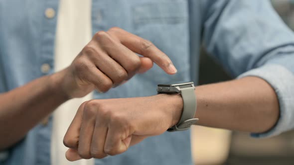 Hands of African Man Using Smartwatch