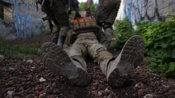 Army Rangers Rescuing Wounded Soldier From Combat