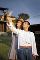Two Friends Smiling and Taking selfie Pictures with a Rainbow in the Ranch. - PhotoDune Item for Sale