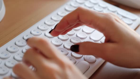 Woman typing on computer keyboard. Closeup 4k footage