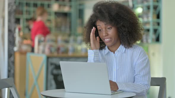 Loss, African Woman Reacting To Failure on Laptop in Cafe 